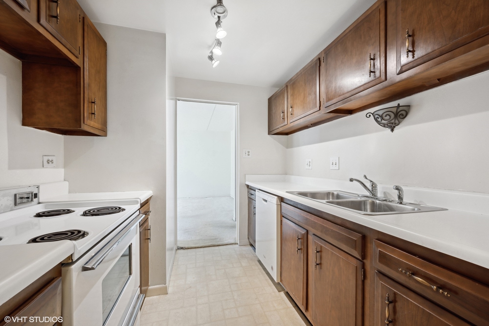 1625 Sheridan Road, Unit 406 Wilmette, IL 60091 - Photo 5 of 10 a kitchen with a sink stove top oven and cabinets