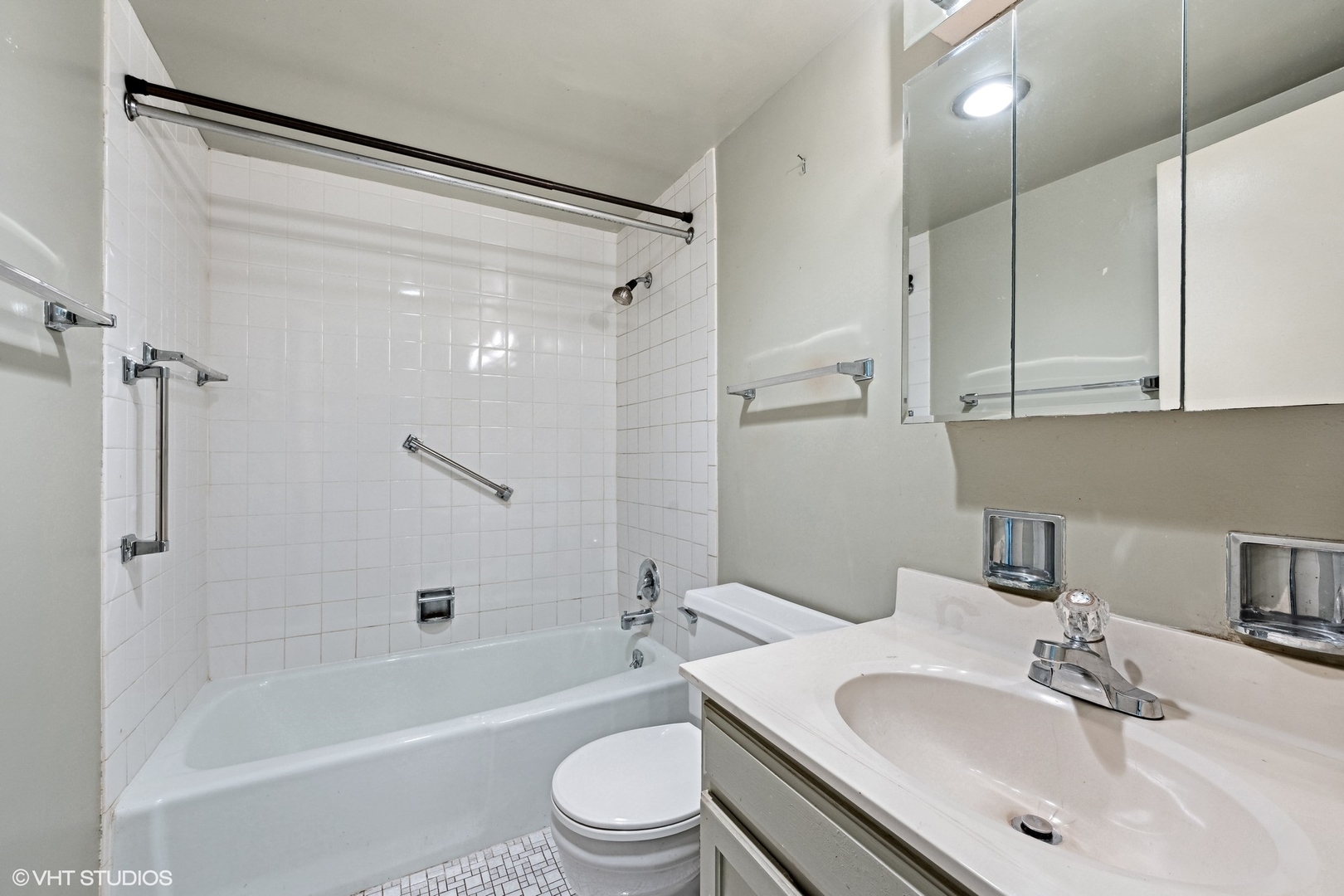 1625 Sheridan Road, Unit 406 Wilmette, IL 60091 - Photo 8 of 10 a bathroom with a sink toilet and shower