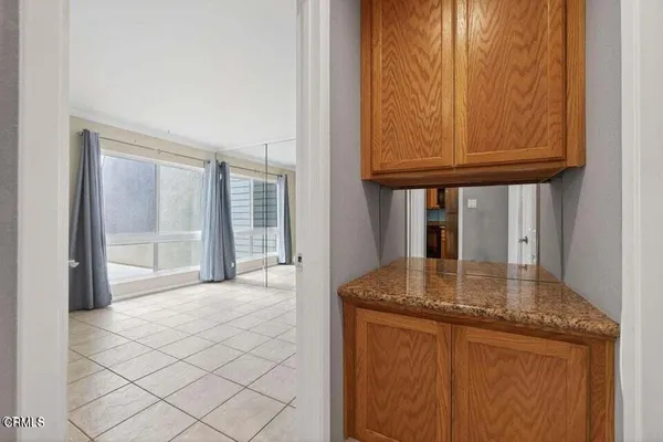 a kitchen with granite countertop a sink and cabinets