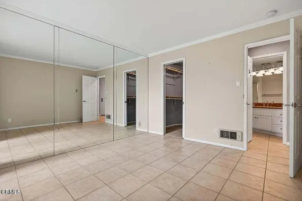 a view of an empty room with window and an empty room