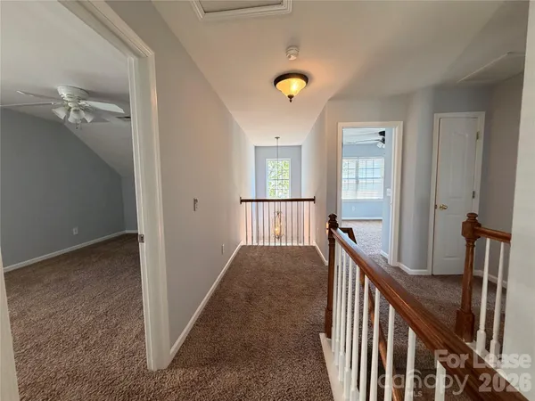 a view of a hallway view with wooden floor and stairs