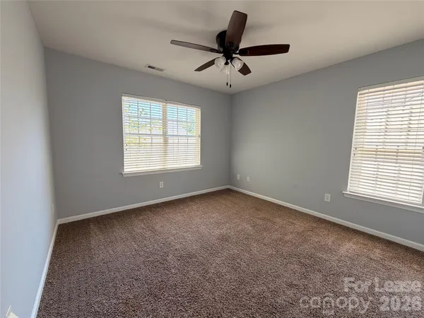 a view of a livingroom with a ceiling fan and window