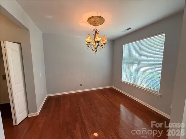 a view of a room with wooden floor and a window