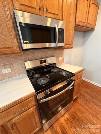 a stove top oven sitting inside of a kitchen