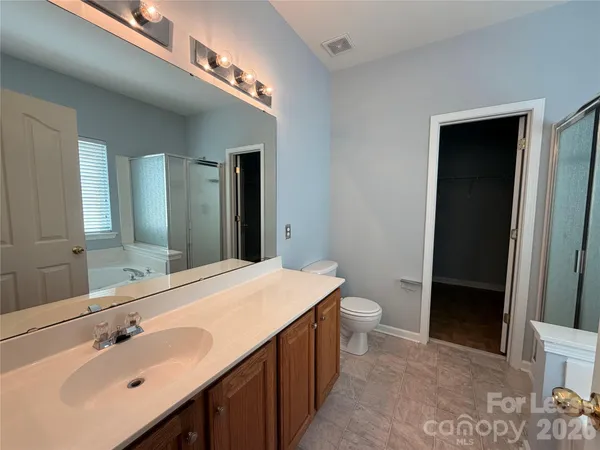 a bathroom with a double vanity sink and a toilet