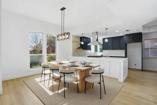 a kitchen with stainless steel appliances kitchen island granite countertop a sink a stove and a refrigerator