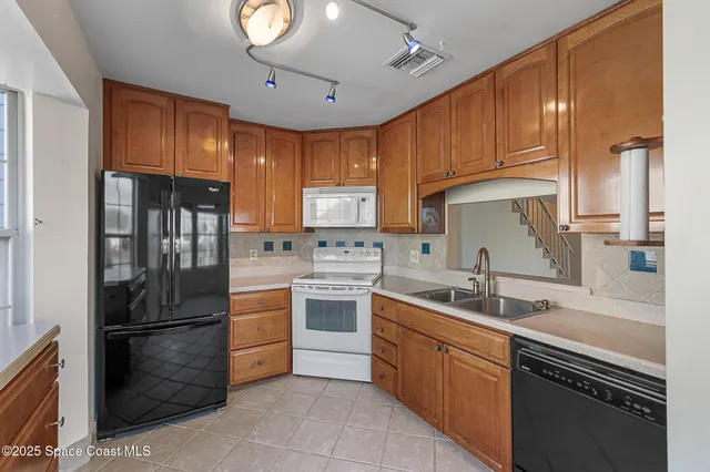 a kitchen with refrigerator cabinets and furniture