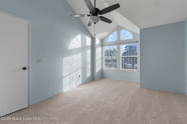 an empty room with windows and closet