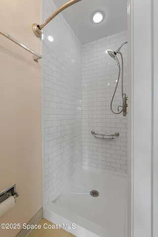 an empty room with windows and ceiling fan view