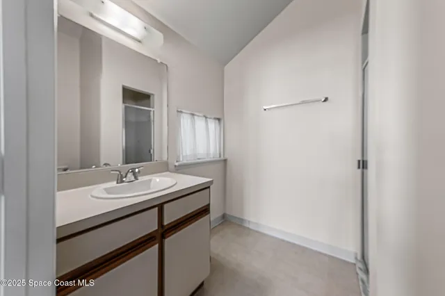 a bathroom with a glass shower door