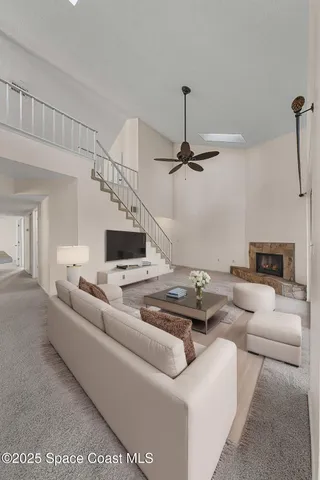 a dining room with furniture a chandelier and wooden floor