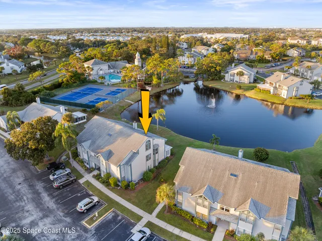 an aerial view of residential houses with outdoor space and lake view