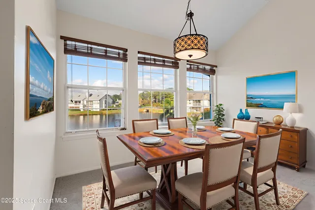 a view of a workspace with furniture and a book shelf