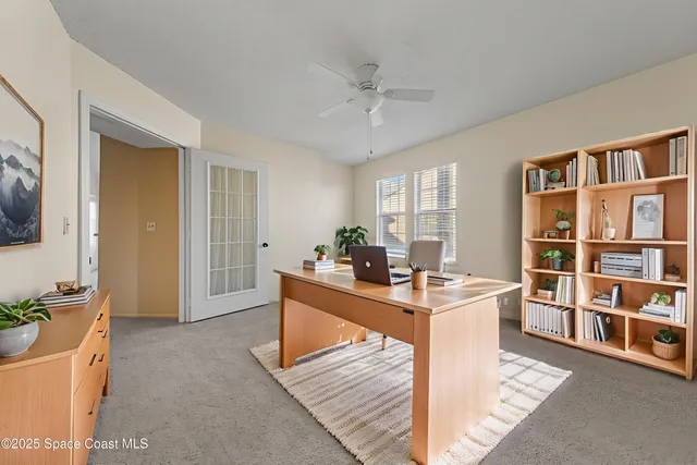 a spacious bedroom with a bed a chandelier and a flat tv screen