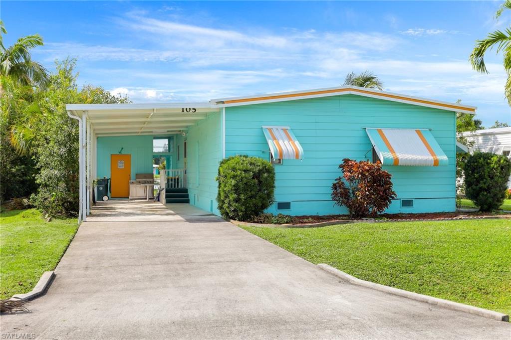 105 Audubon Road Naples, FL 34114 - Photo 1 of 30 a front view of a house with a yard and garage