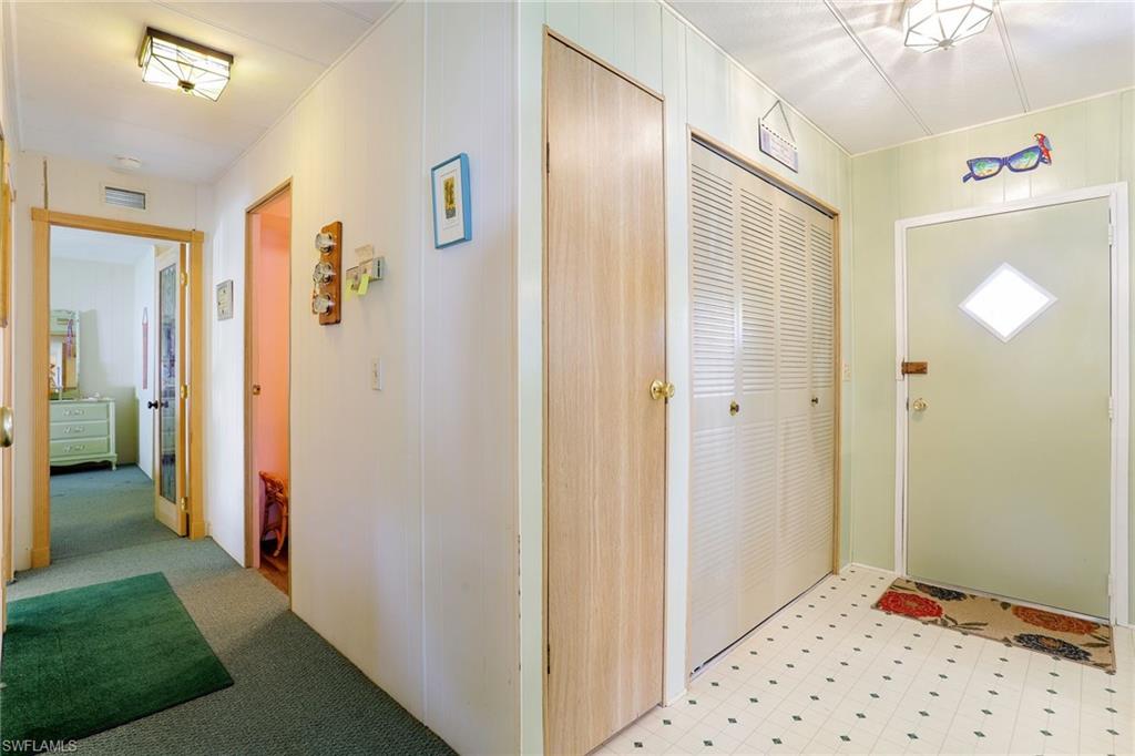 105 Audubon Road Naples, FL 34114 - Photo 14 of 30 a view of a hallway with bathroom and shower