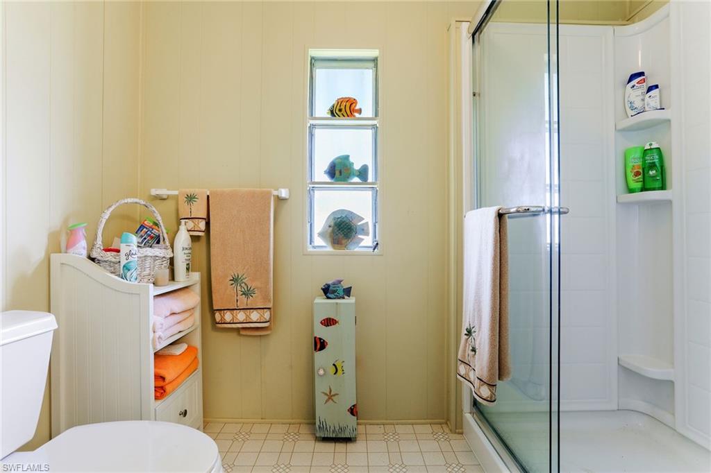 105 Audubon Road Naples, FL 34114 - Photo 16 of 30 a bathroom with a sink toilet and shower
