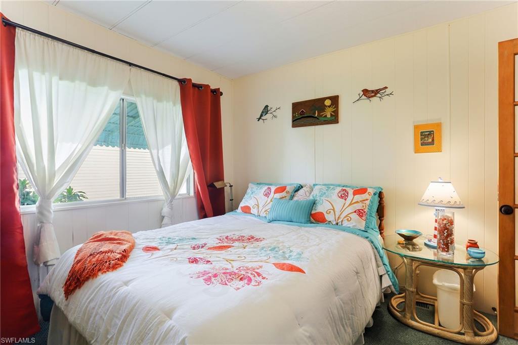 105 Audubon Road Naples, FL 34114 - Photo 18 of 30 a bedroom with a bed and a window