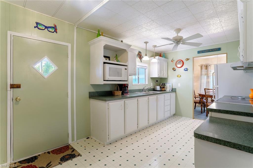 105 Audubon Road Naples, FL 34114 - Photo 2 of 30 a kitchen with a refrigerator and a stove top oven