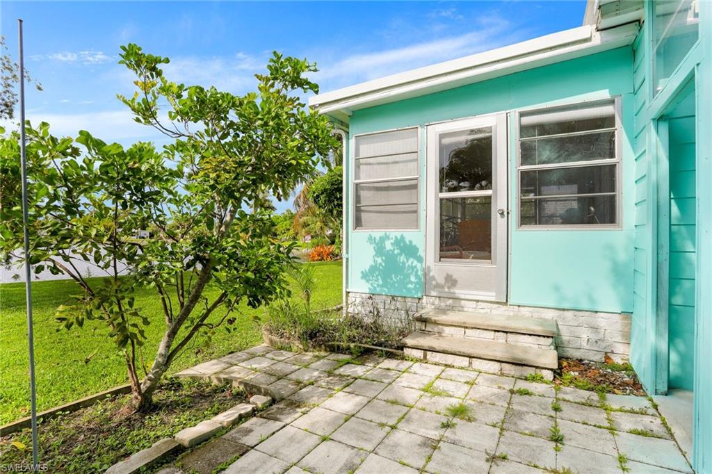 105 Audubon Road Naples, FL 34114 - Photo 23 of 30 a front view of a house with a yard