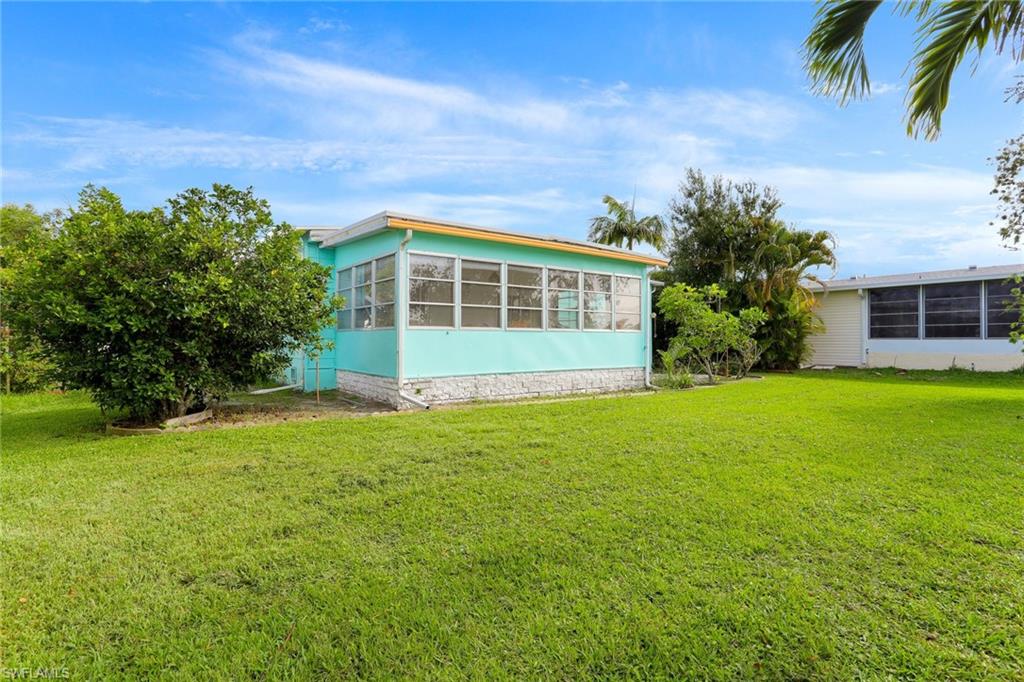 105 Audubon Road Naples, FL 34114 - Photo 26 of 30 a view of a house with a yard