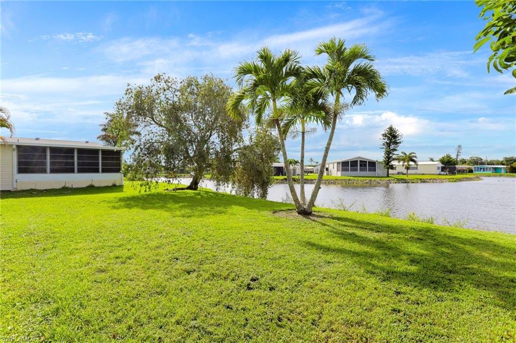 105 Audubon Road Naples, FL 34114 - Photo 27 of 30 a view of a house with swimming pool and a yard