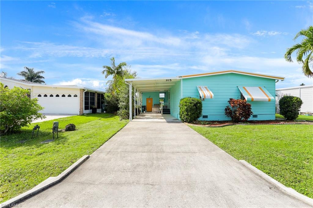 105 Audubon Road Naples, FL 34114 - Photo 30 of 30 a front view of a house with garden