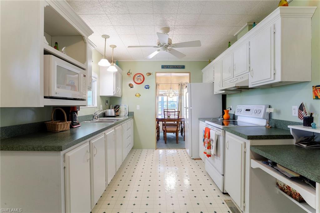 105 Audubon Road Naples, FL 34114 - Photo 4 of 30 a kitchen with granite countertop lots of counter top space
