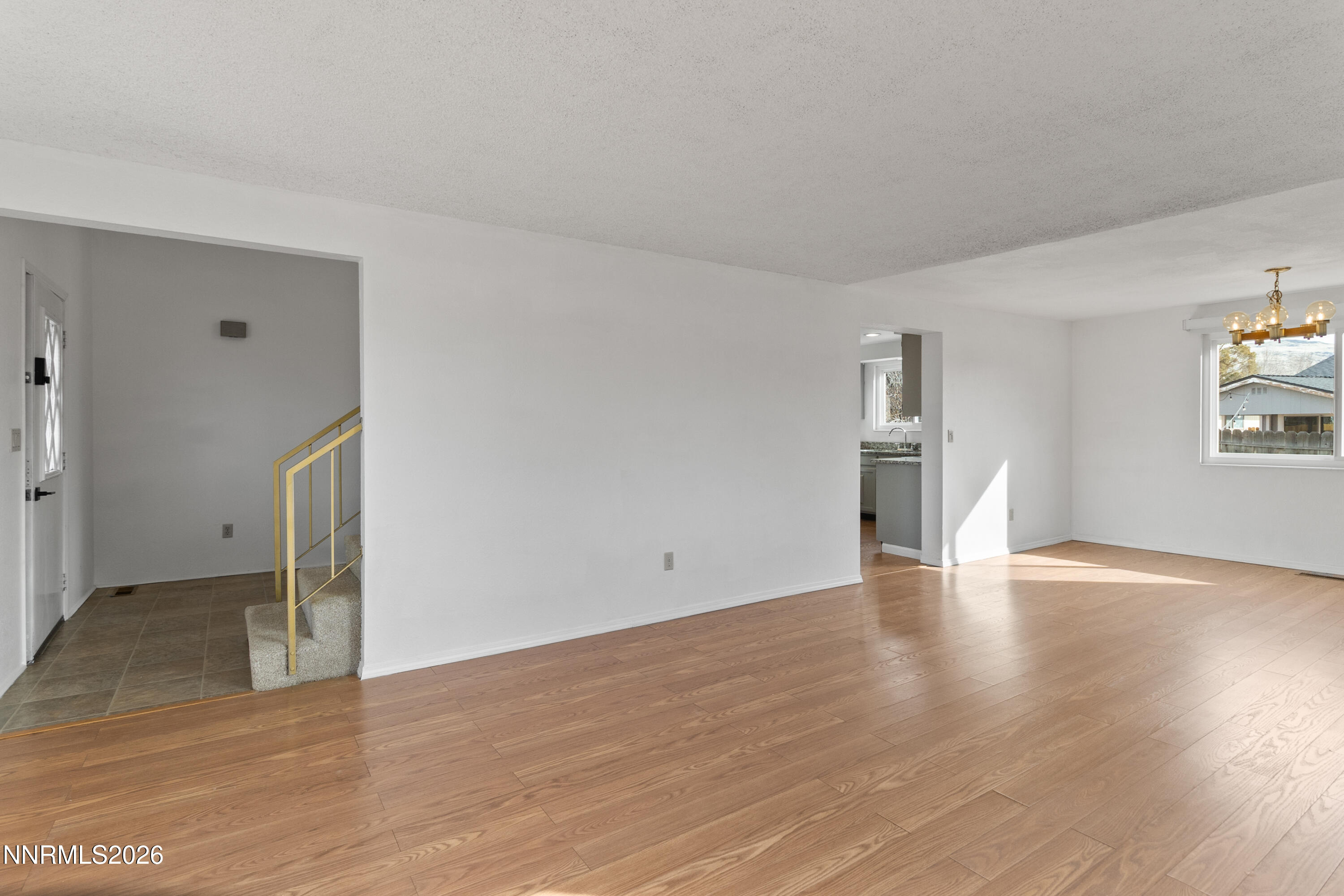 3142 Jarbidge Way Sparks, NV 89434 - Photo 11 of 42 a view of an empty room with wooden floor and a window