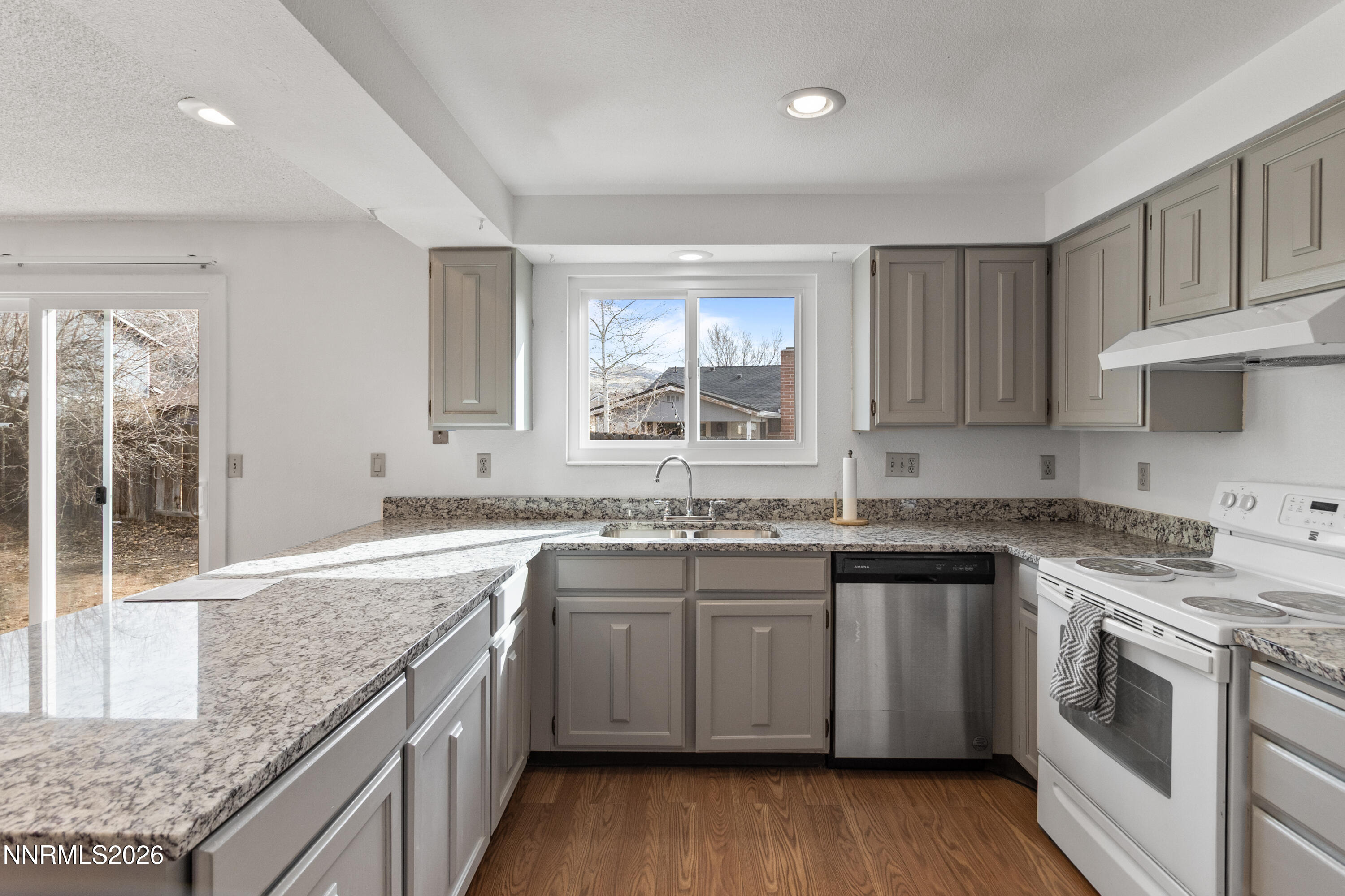 3142 Jarbidge Way Sparks, NV 89434 - Photo 14 of 42 a kitchen with a sink stove cabinets and wooden floor