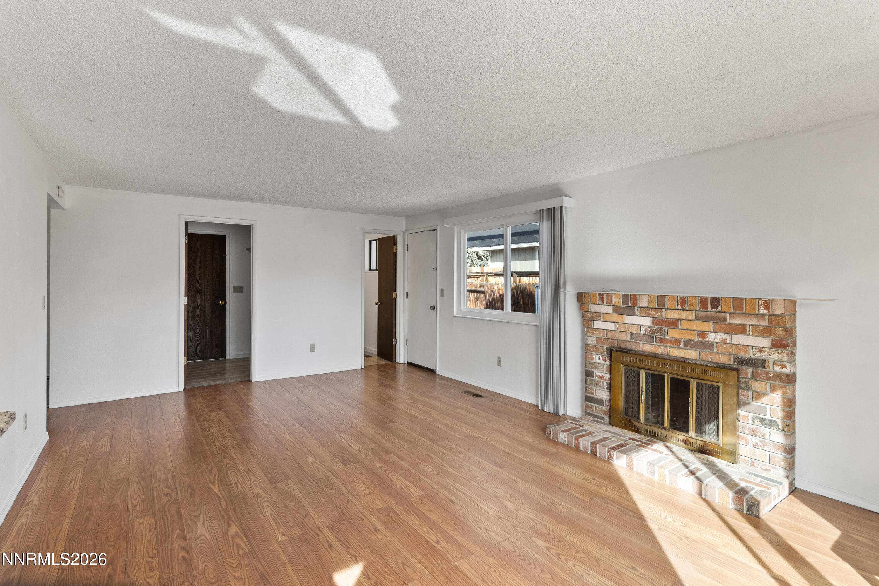 3142 Jarbidge Way Sparks, NV 89434 - Photo 17 of 42 a view of a livingroom with wooden floor and kitchen view