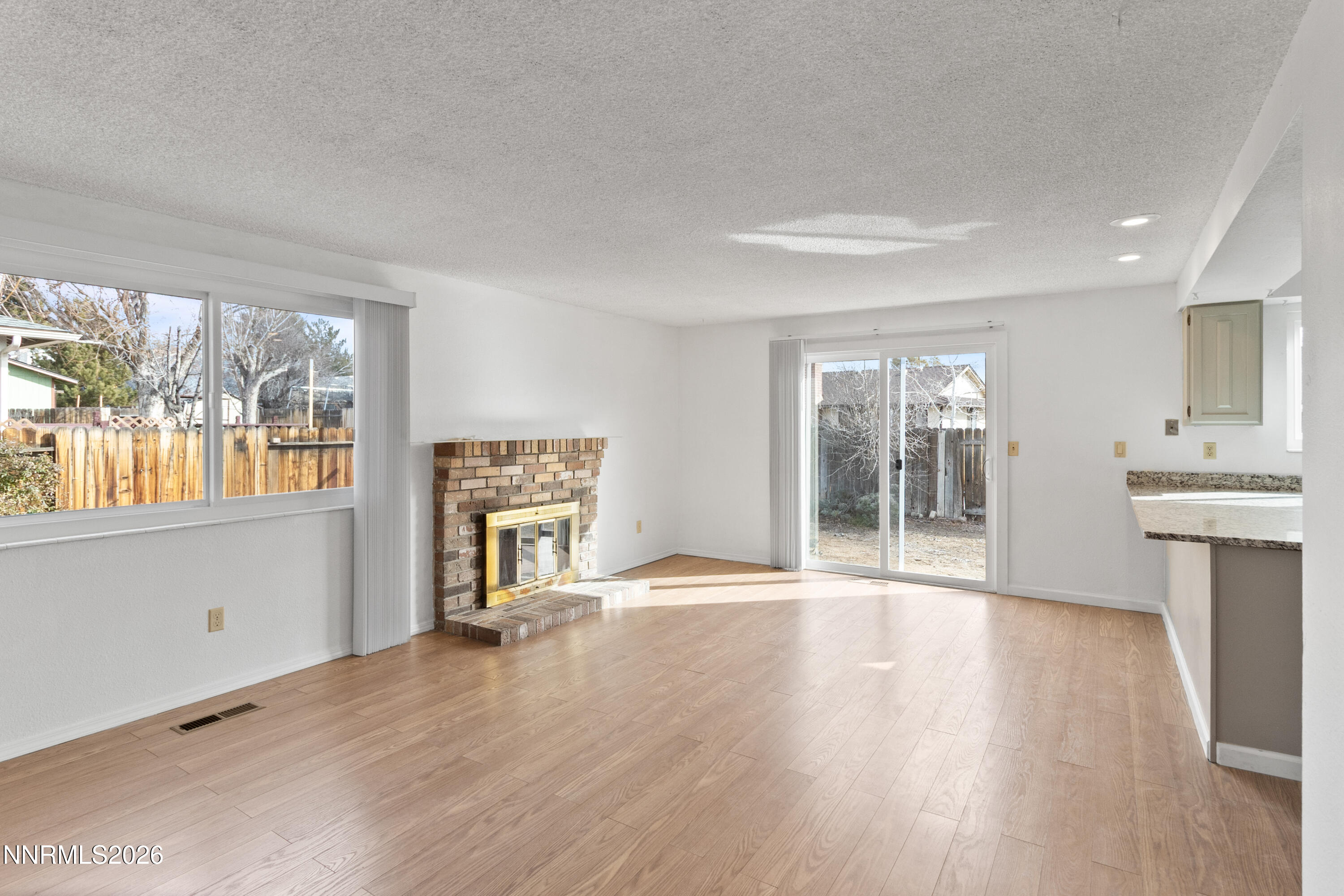 3142 Jarbidge Way Sparks, NV 89434 - Photo 18 of 42 a view of an empty room with glass door and wooden floor
