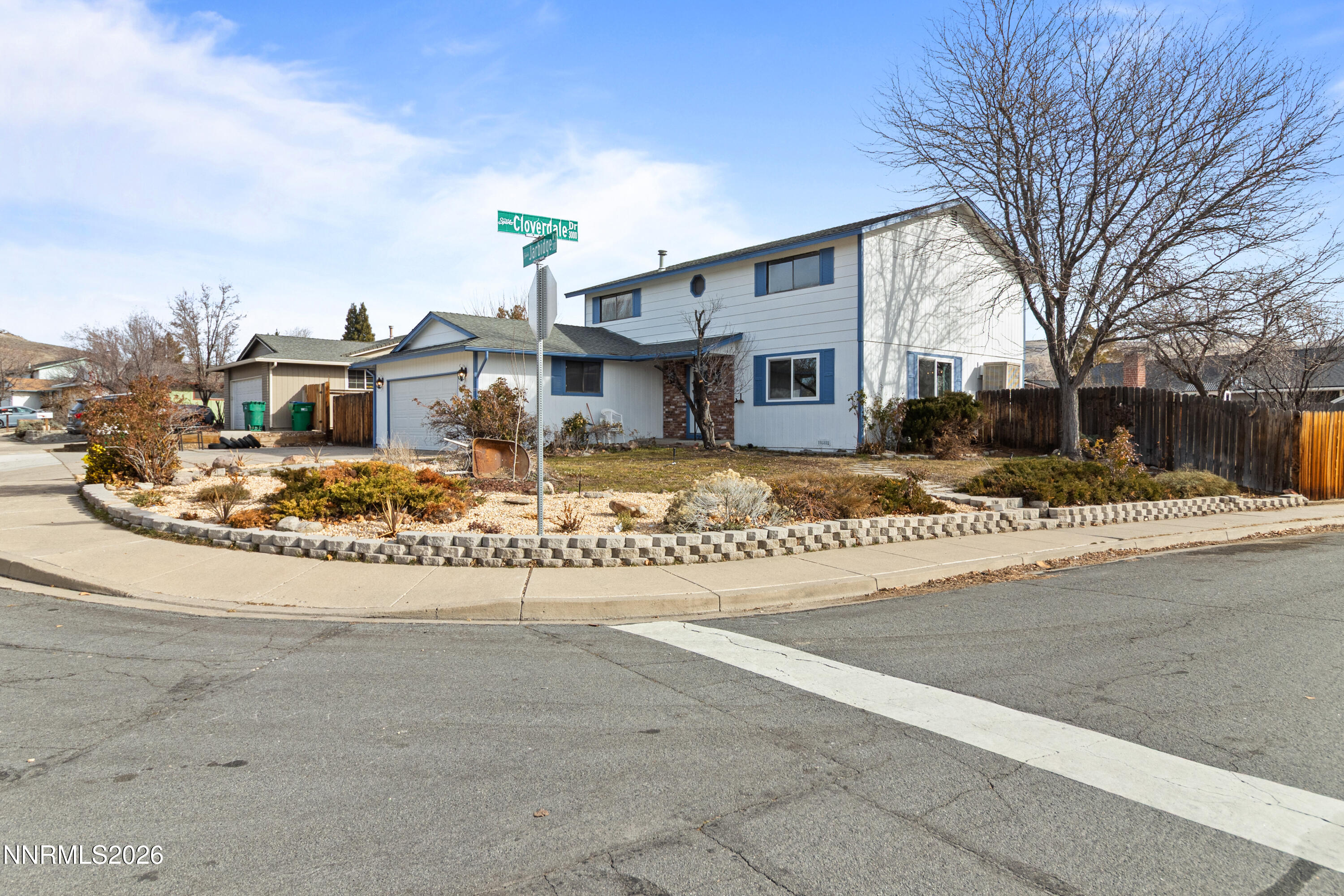 3142 Jarbidge Way Sparks, NV 89434 - Photo 4 of 42 a view of a white house next to a road with big trees