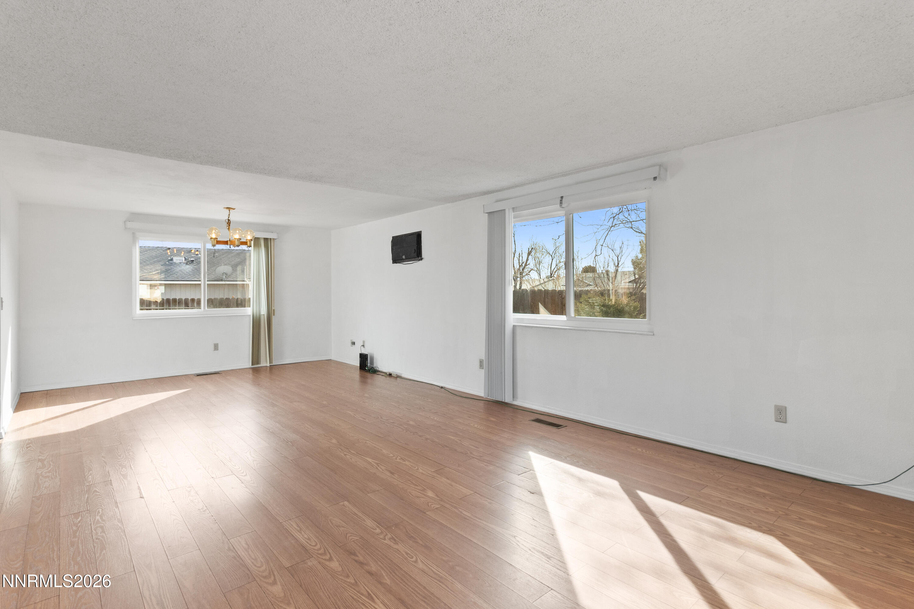 3142 Jarbidge Way Sparks, NV 89434 - Photo 10 of 42 a view of an empty room with a window and wooden floor