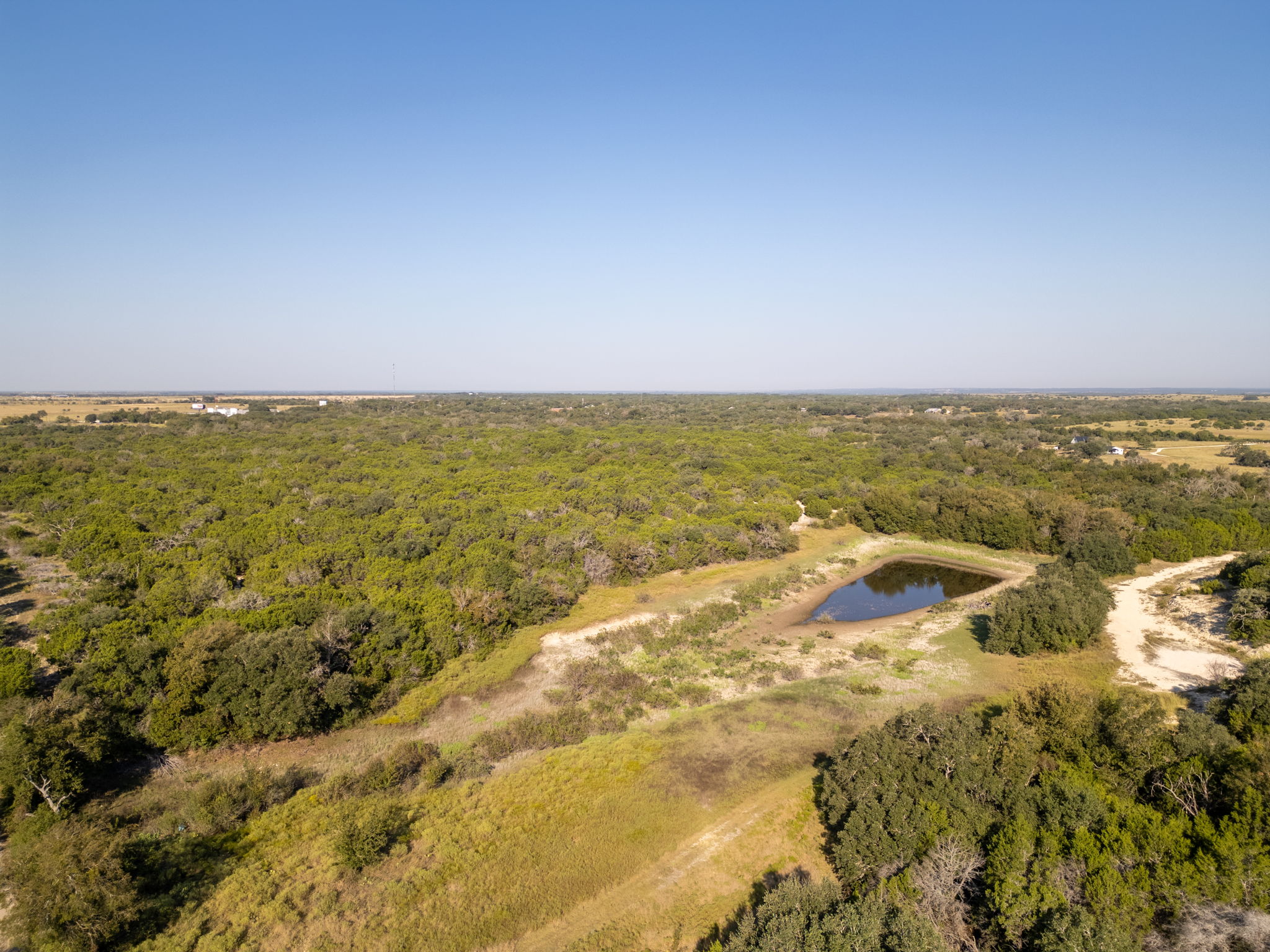 112 Loop 308 Briggs, TX 78608 - Photo 30 of 37 Aerial view of a nearby body of water and a forest