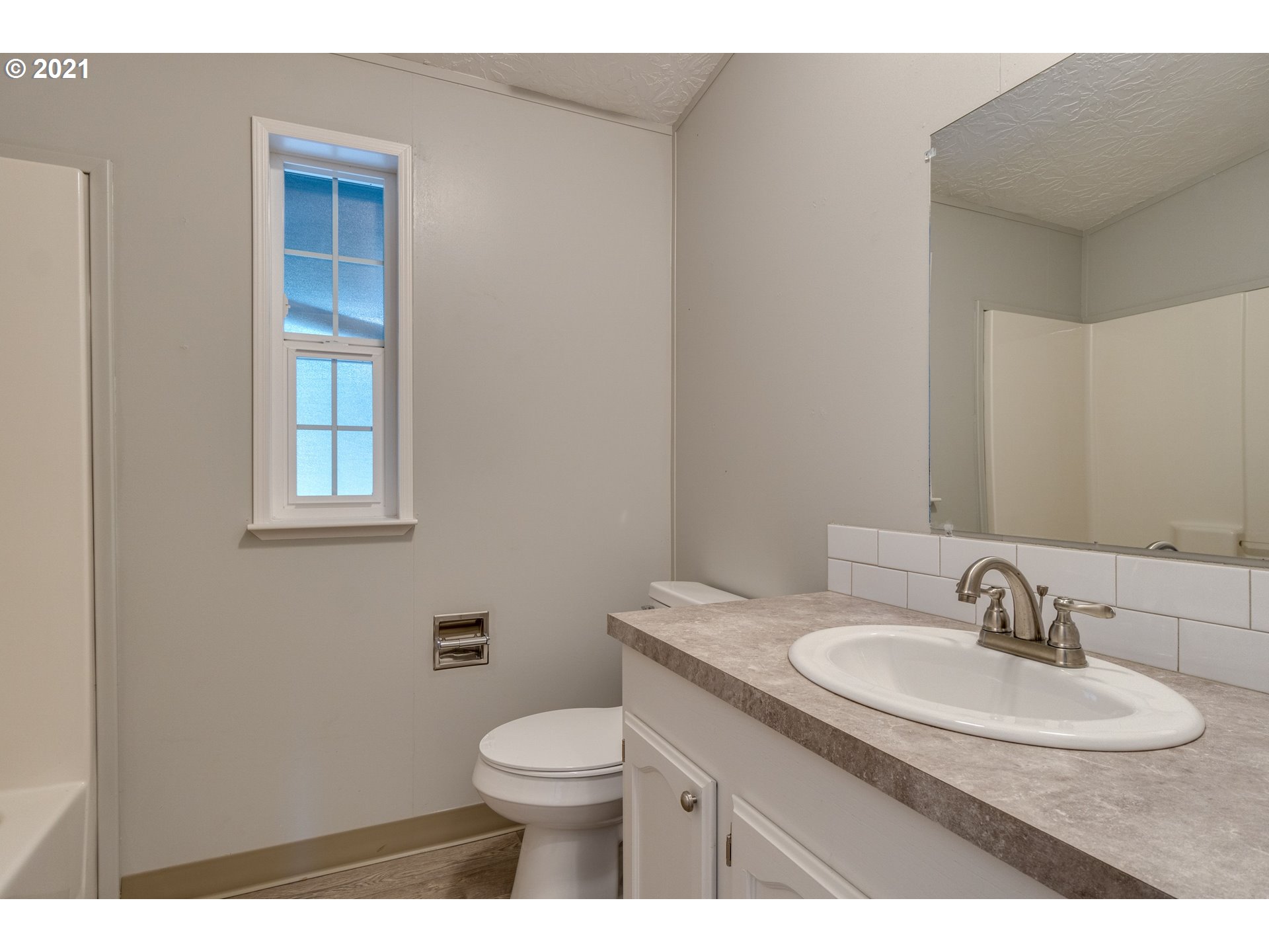 26116 Pellham Hill Road Rainier, OR 97048 - Photo 16 of 32 a bathroom with a sink toilet and vanity