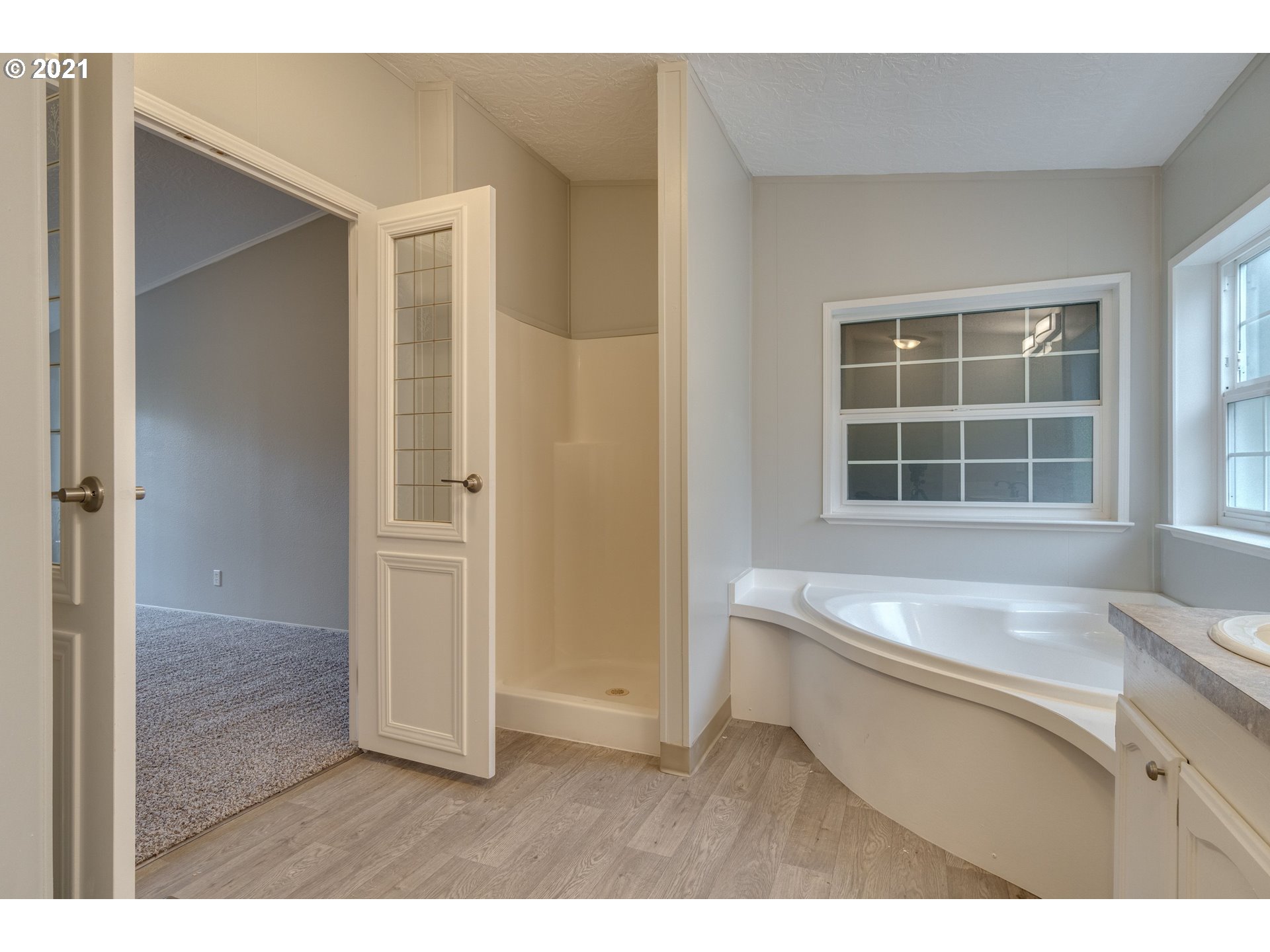 26116 Pellham Hill Road Rainier, OR 97048 - Photo 22 of 32 a living room with a large window and a kitchen view