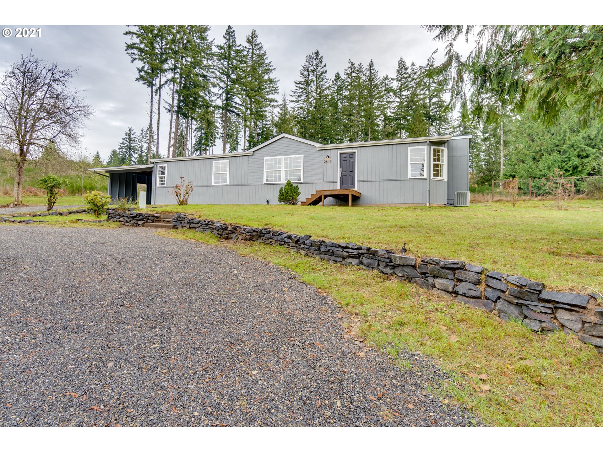26116 Pellham Hill Road Rainier, OR 97048 - Photo 31 of 32 a view of a house with a yard and a large tree