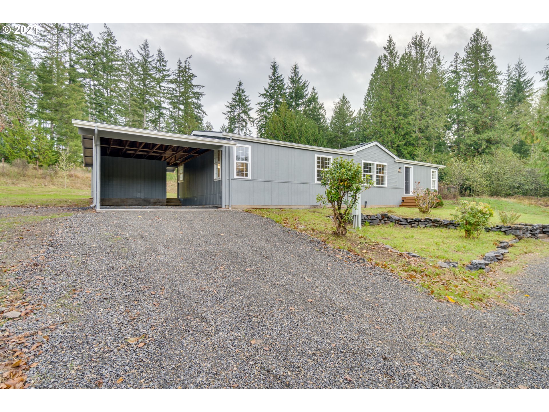 26116 Pellham Hill Road Rainier, OR 97048 - Photo 32 of 32 a view of a house with backyard and trees