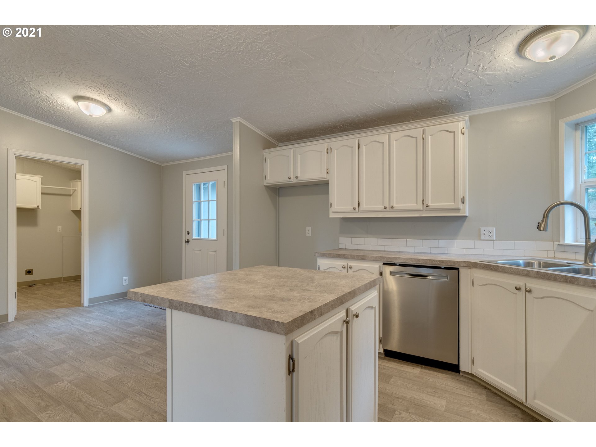 26116 Pellham Hill Road Rainier, OR 97048 - Photo 10 of 32 a kitchen with a sink cabinets and wooden floor