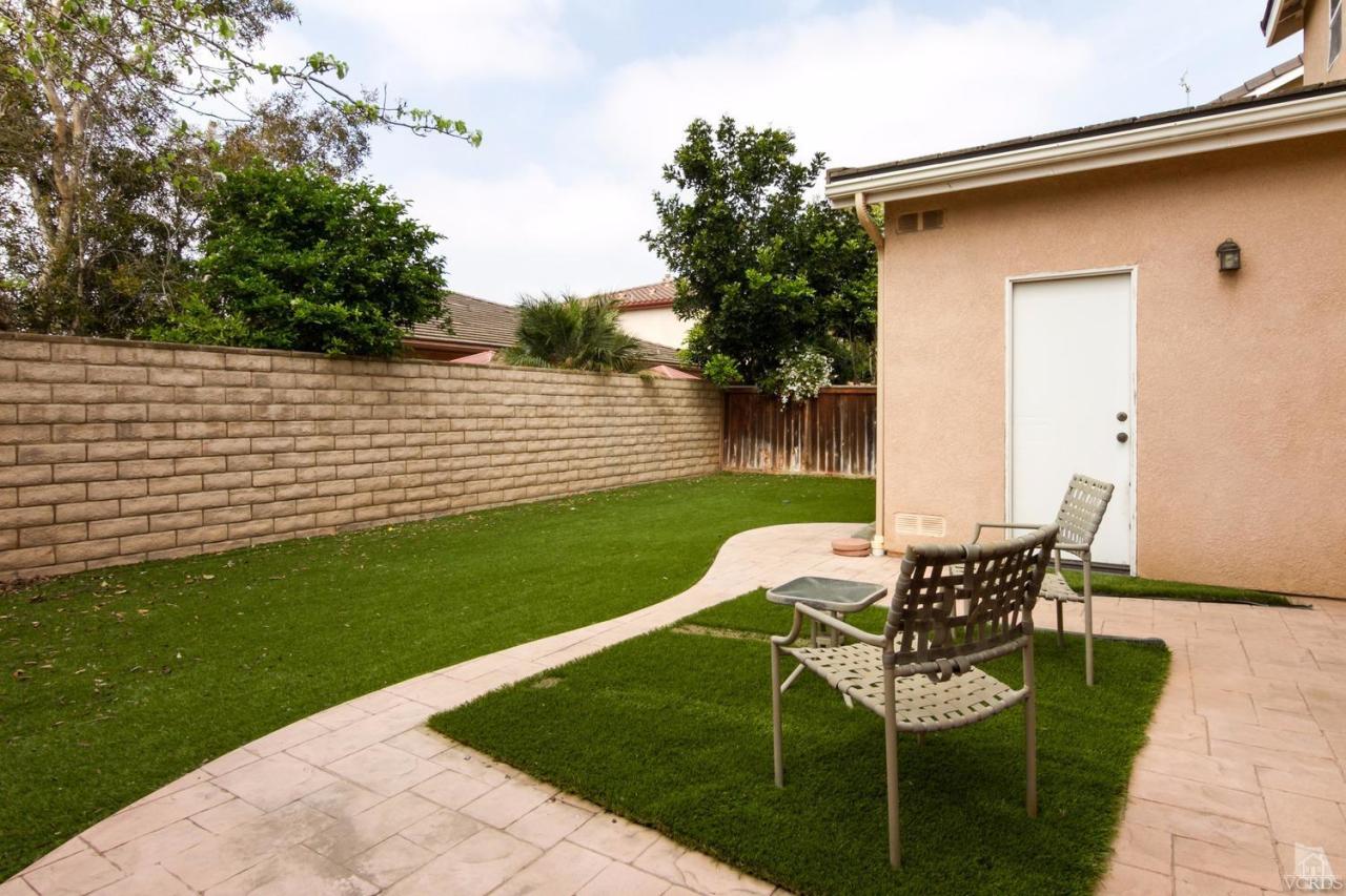 1731 Sonata Drive Oxnard, CA 93030 - Photo 14 of 15 a view of a patio with table and chairs and potted plants with wooden fence