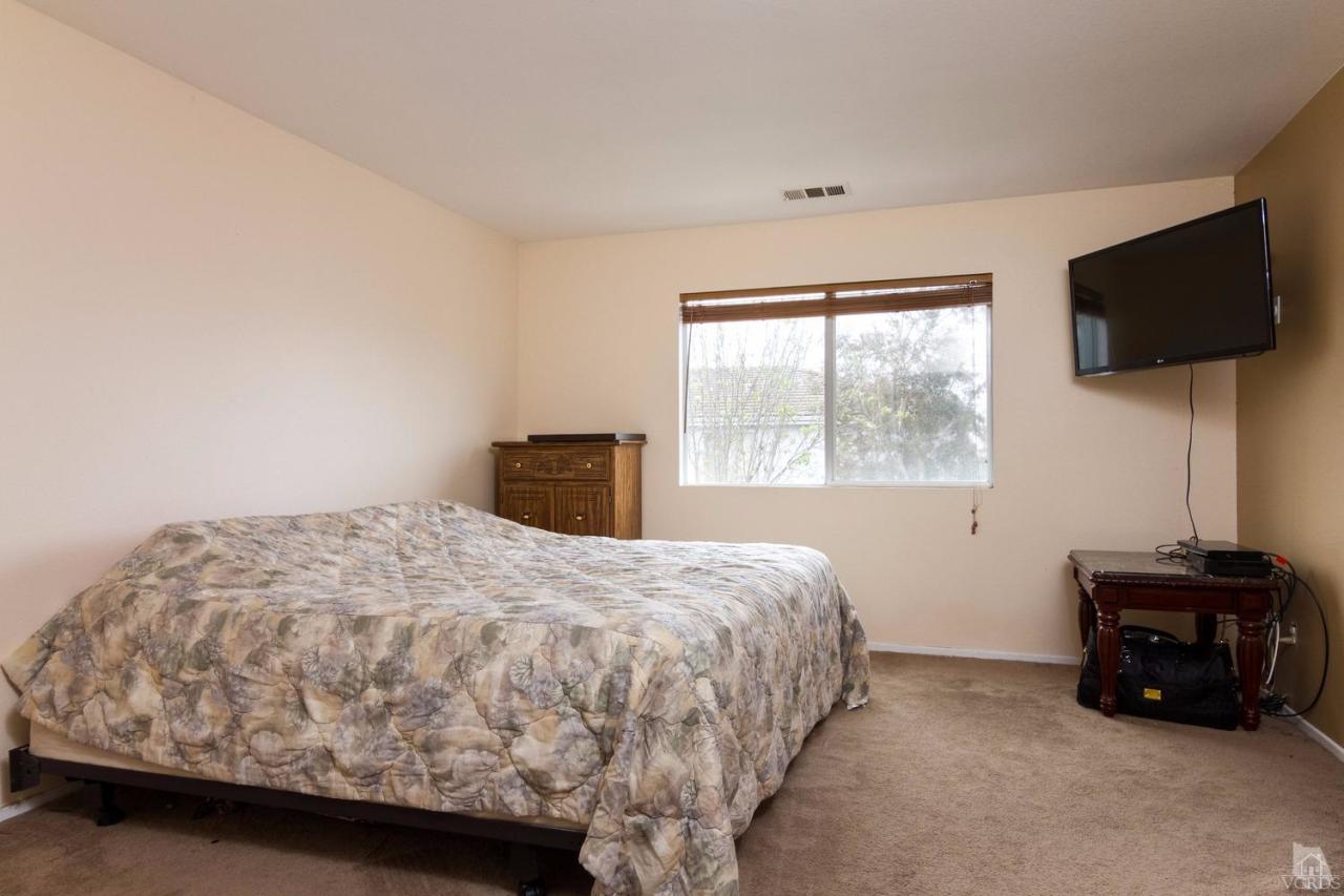 1731 Sonata Drive Oxnard, CA 93030 - Photo 9 of 15 a bedroom with a bed and a flat screen tv