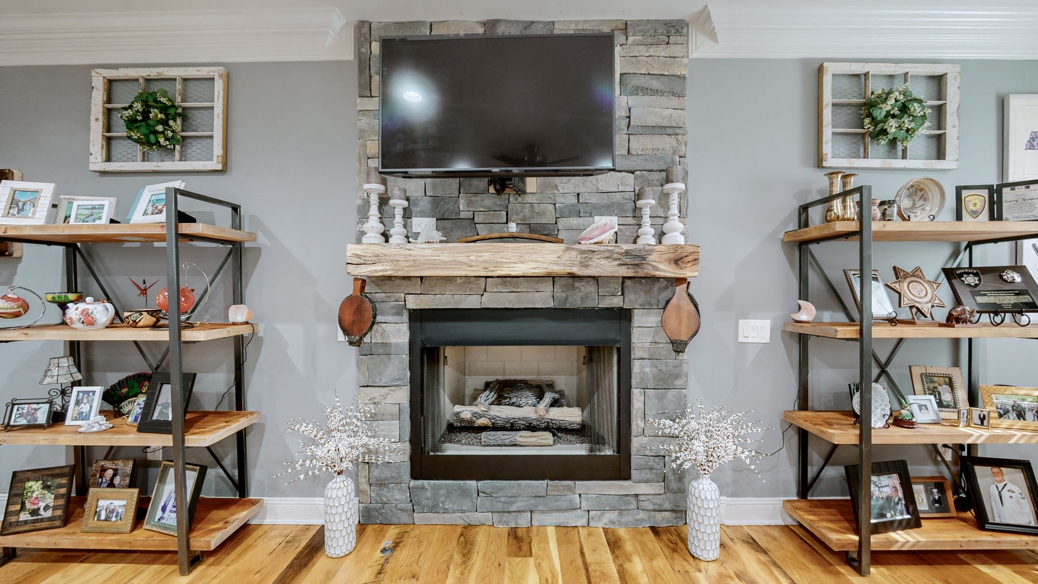 1019 Parker Road Kingston Springs, TN 37082 - Photo 9 of 39 a living room with fireplace furniture and a flat screen tv
