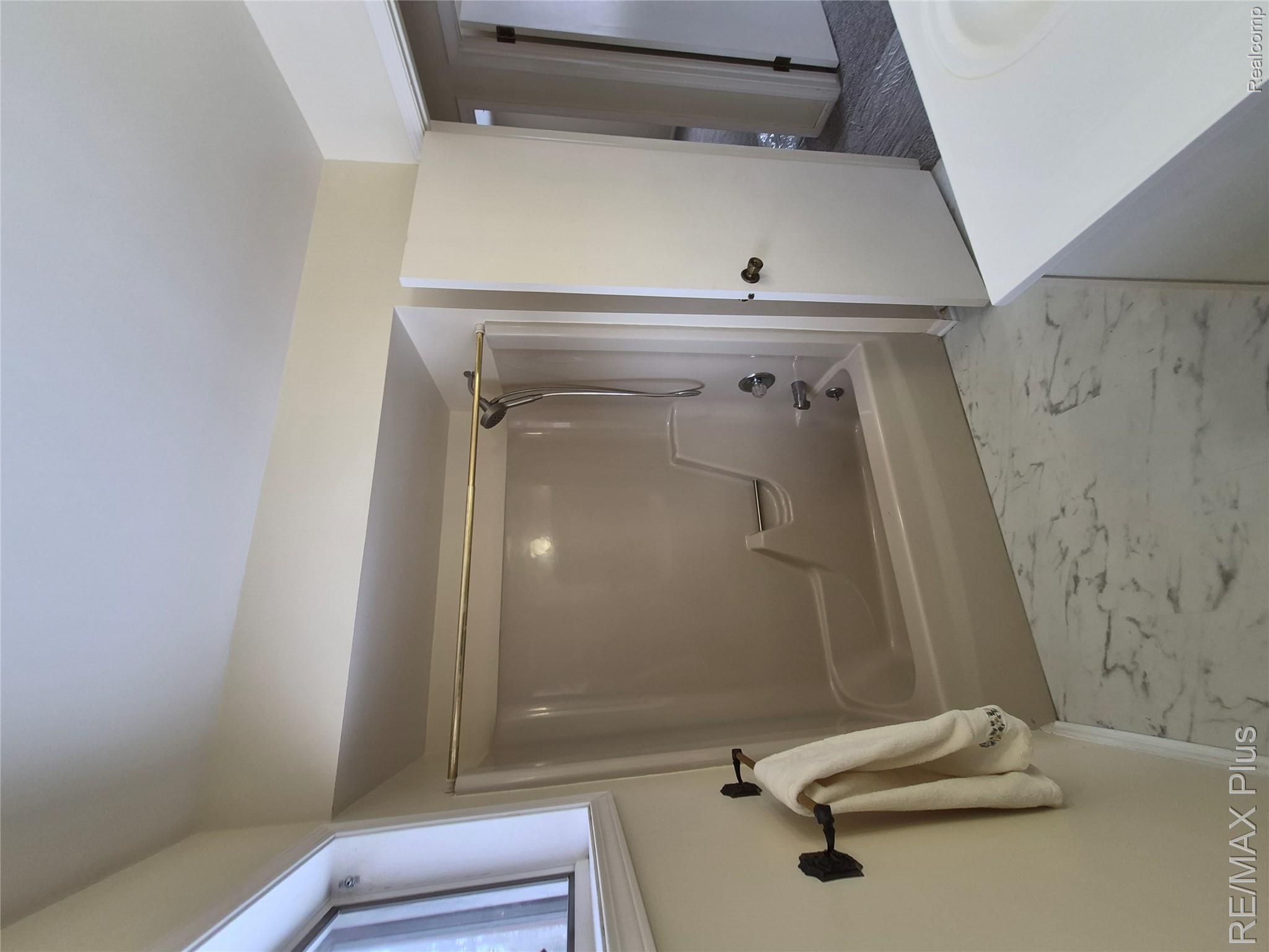 1115 Turrill Road Lapeer, MI 48446 - Photo 29 of 50 Bathroom featuring shower / tub combination, vanity, and light marble finish flooring