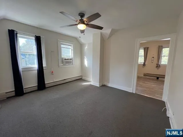 an empty room with fan and mirror