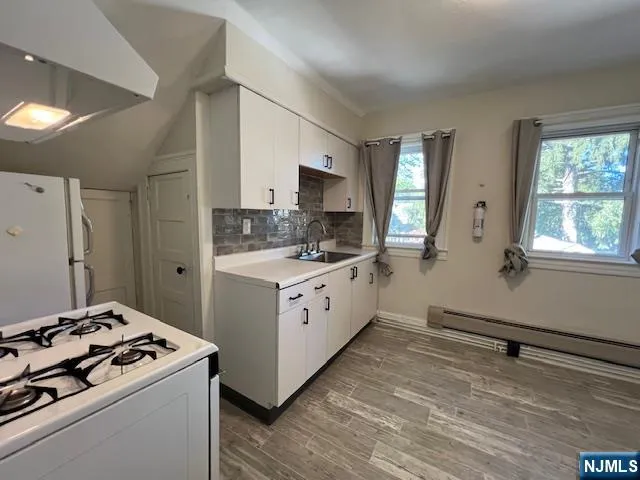 a kitchen with a stove a sink and a refrigerator