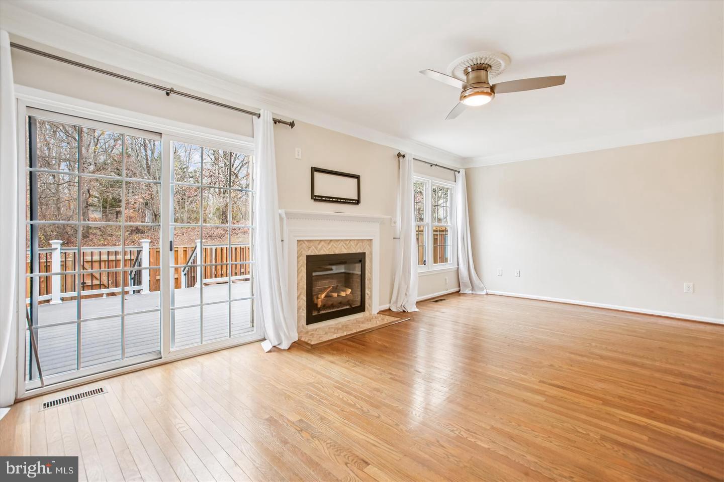 7728 Hickory Glen Way Springfield, VA 22153 - Photo 15 of 35 wooden floor fireplace and windows in an empty room