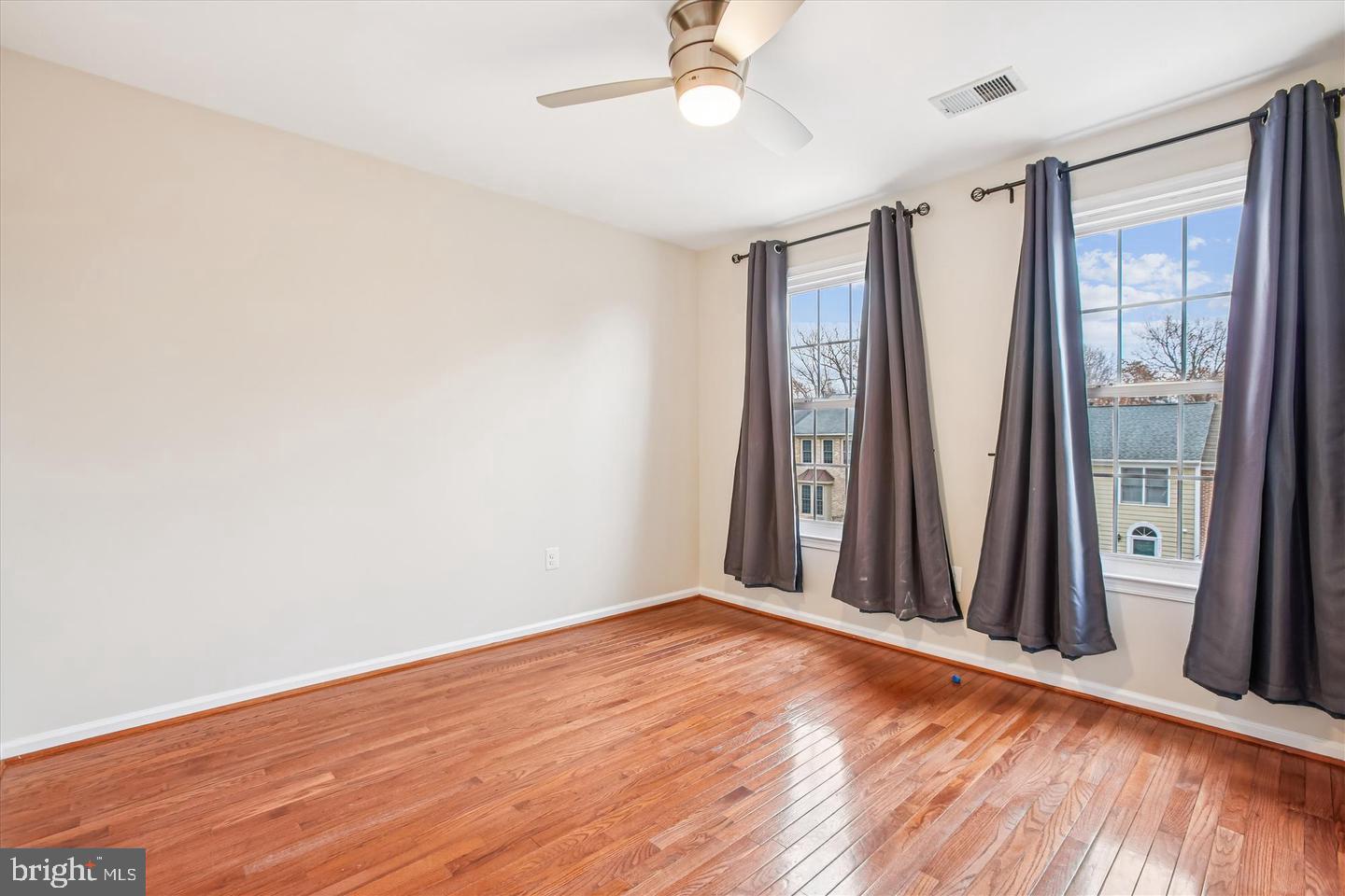 7728 Hickory Glen Way Springfield, VA 22153 - Photo 21 of 35 an empty room with wooden floor and a window
