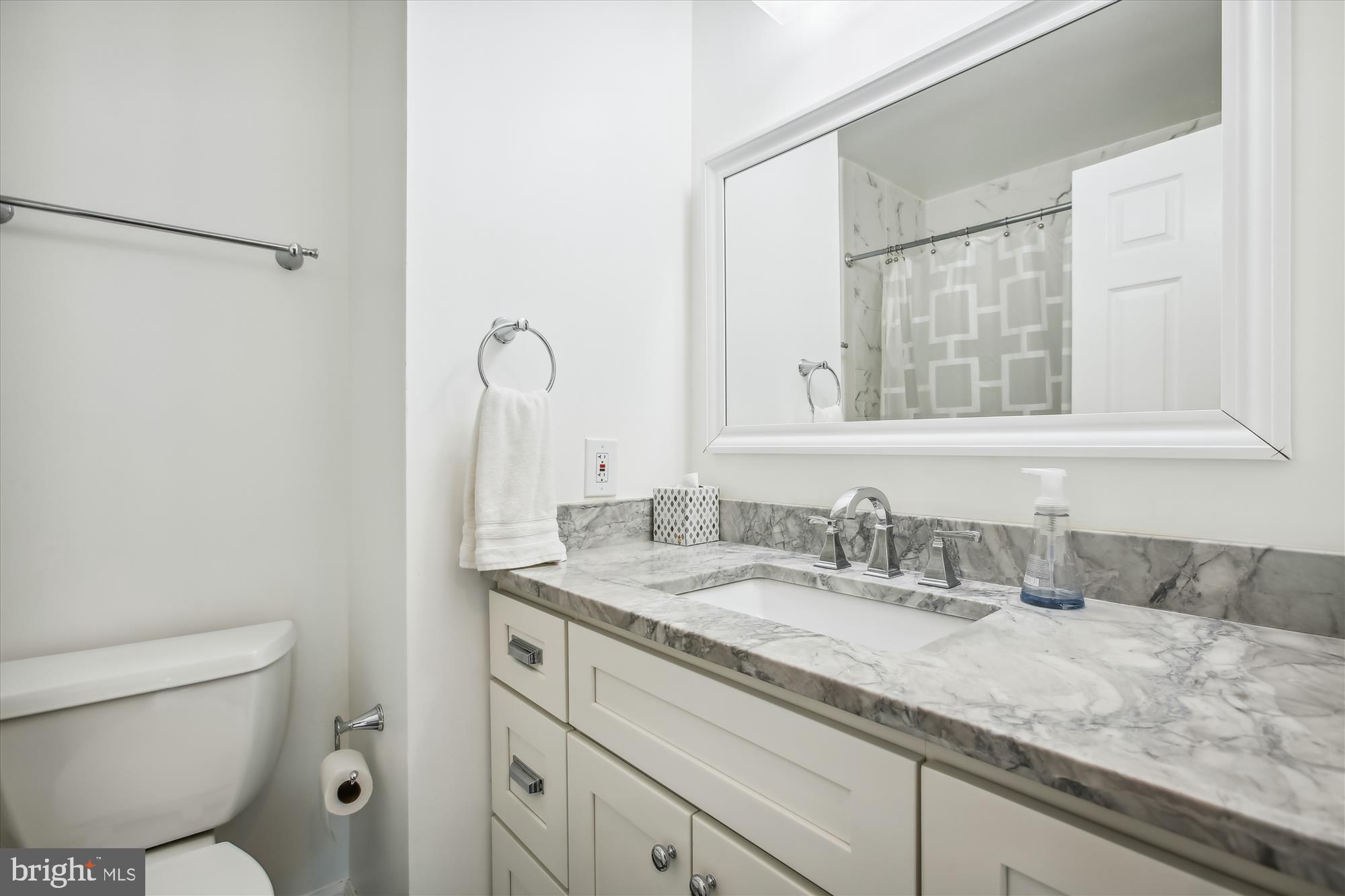 7728 Hickory Glen Way Springfield, VA 22153 - Photo 25 of 35 a bathroom with a granite countertop sink a toilet and a mirror