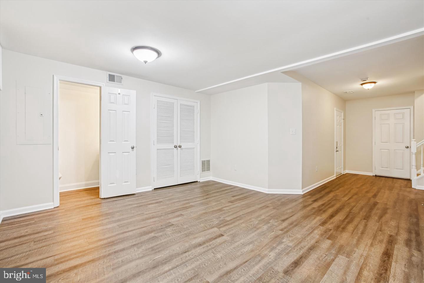 7728 Hickory Glen Way Springfield, VA 22153 - Photo 28 of 35 a view of an empty room with wooden floor